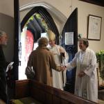 Bishop Alan & Revd. Lizzie Hood greeting the depearting members of the congregation.